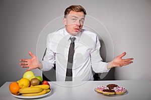 Man choosing between healthy and unhealthy food