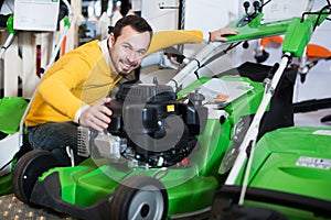 Man choosing lawnmower