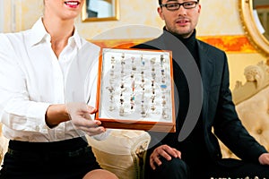 Man choosing a ring at the jeweller photo