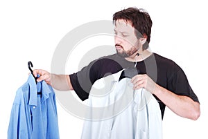 Man choosing between two shirts