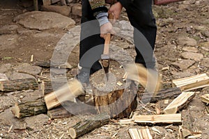 Man chopping fire wood logs with motion blur photo