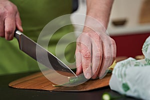 Man chopping green chili