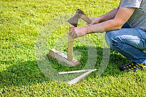 Man is chopping a log with an axe