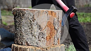 a man chopping wood with an ax a log red . chopping wood with an ax