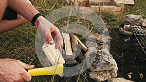 Man chopping wood with an axe for fire camp, bbq