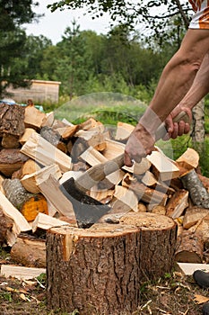 Man is chopping wood with axe