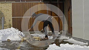 Man chopping wood in snow yard winter village