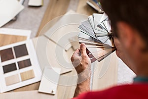 Man chosing the right flooring for his house photo