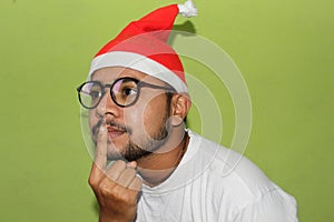 Man with christmas hat silent quiet gesture