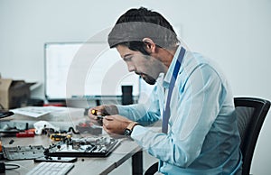 Man, circuit and tools at repair workshop for maintenance, computer tech or industry with focus. Technician, motherboard