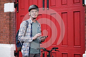 Man with city bicycle and mobile phone
