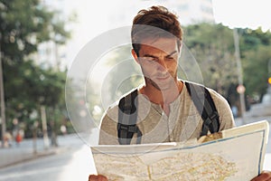 Man, city and tourist with map for destination, location or tour guide in street or road. Male person or traveler