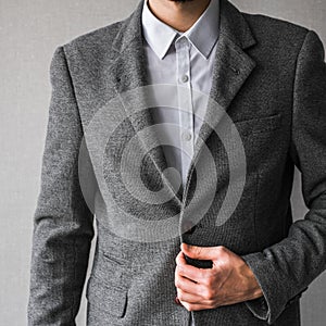 A man in a classic gray jacket and white shirt on a light background. businessman in a suit. mockup