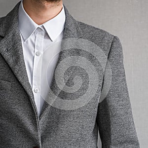 A man in a classic gray jacket and white shirt on a light background. businessman in a suit. mockup