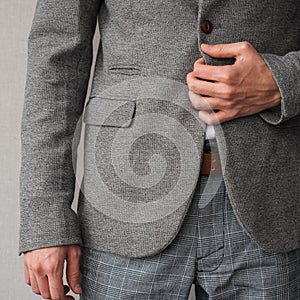 A man in a classic gray jacket and white shirt on a light background. businessman in a suit. mockup