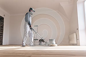 Man clean the parquet with polishing machine