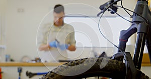 Man cleaning bicycle parts on counter 4k