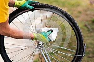 Man cleaning bicycle tire for new season