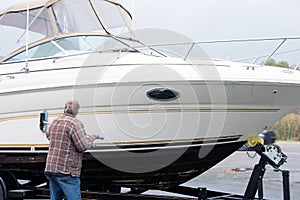 Man cleaning boat hull