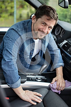 Man cleaning car interior