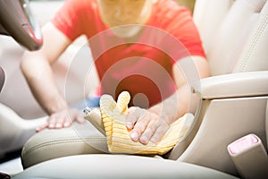 A man cleaning car interior