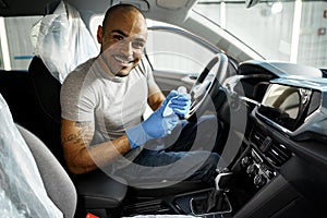 A man cleaning car interior, car detailing in Carwash service