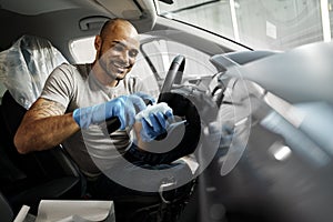 A man cleaning car interior, car detailing in Carwash service