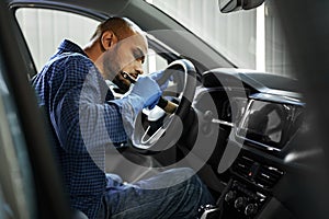 A man cleaning car interior, car detailing in Carwash service