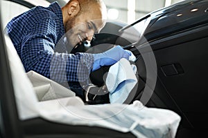 A man cleaning car interior, car detailing in Carwash service