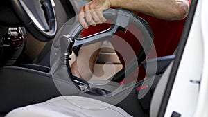 Man cleaning car interior with vacuum cleaner