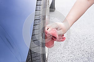 Man cleaning car with microfiber cloth