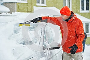 Man cleaning car from snow