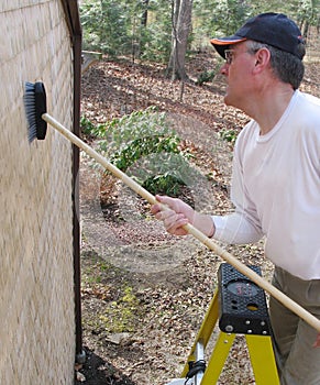 Man cleaning cedar shingles