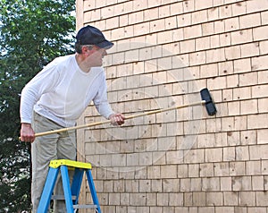 Man cleaning cedar shingles