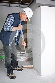 Man cleaning construction site