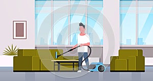 Man cleaning couch with vacuum cleaner guy doing housework concept modern living room interior male cartoon character