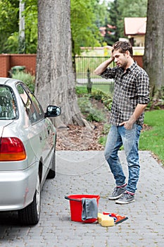 Man before cleaning dirty car