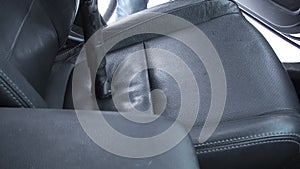 Man cleaning dirty car interior with vacuum cleaner