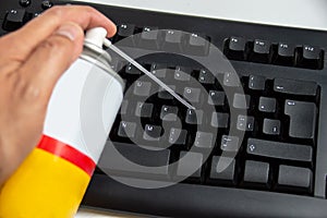 Man cleaning dust from computer