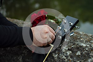 Man cleaning guitar on the Roman Bridge in Sarajevo