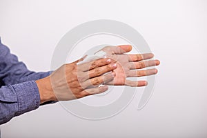 Man cleaning hands with wet wipes