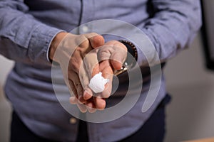 Man cleaning hands with wet wipes