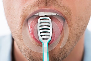 Man Cleaning Her Tongue