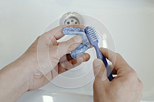 man cleaning his occlusal splint