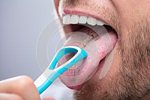 Man Cleaning His Tongue