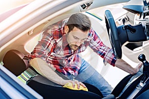 Man cleaning the interior of his car