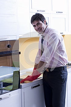 Man cleaning kitchen counter