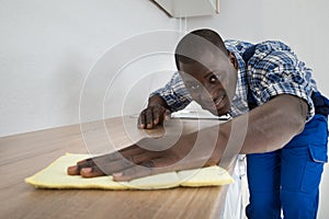 Man Cleaning Kitchen Worktop