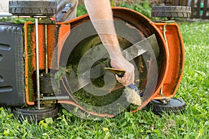 Man cleaning lawn mower