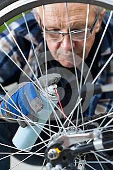 Man cleaning and oiling a bicycle chain